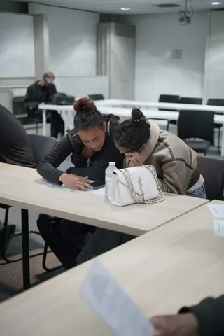 Two participants filling in a worksheet together