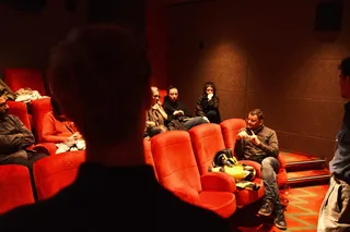 The audience in the red seats of a cinema at a Locked Out event