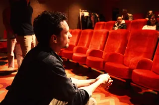 A participant listening in the cinema hall at a Locked Out event