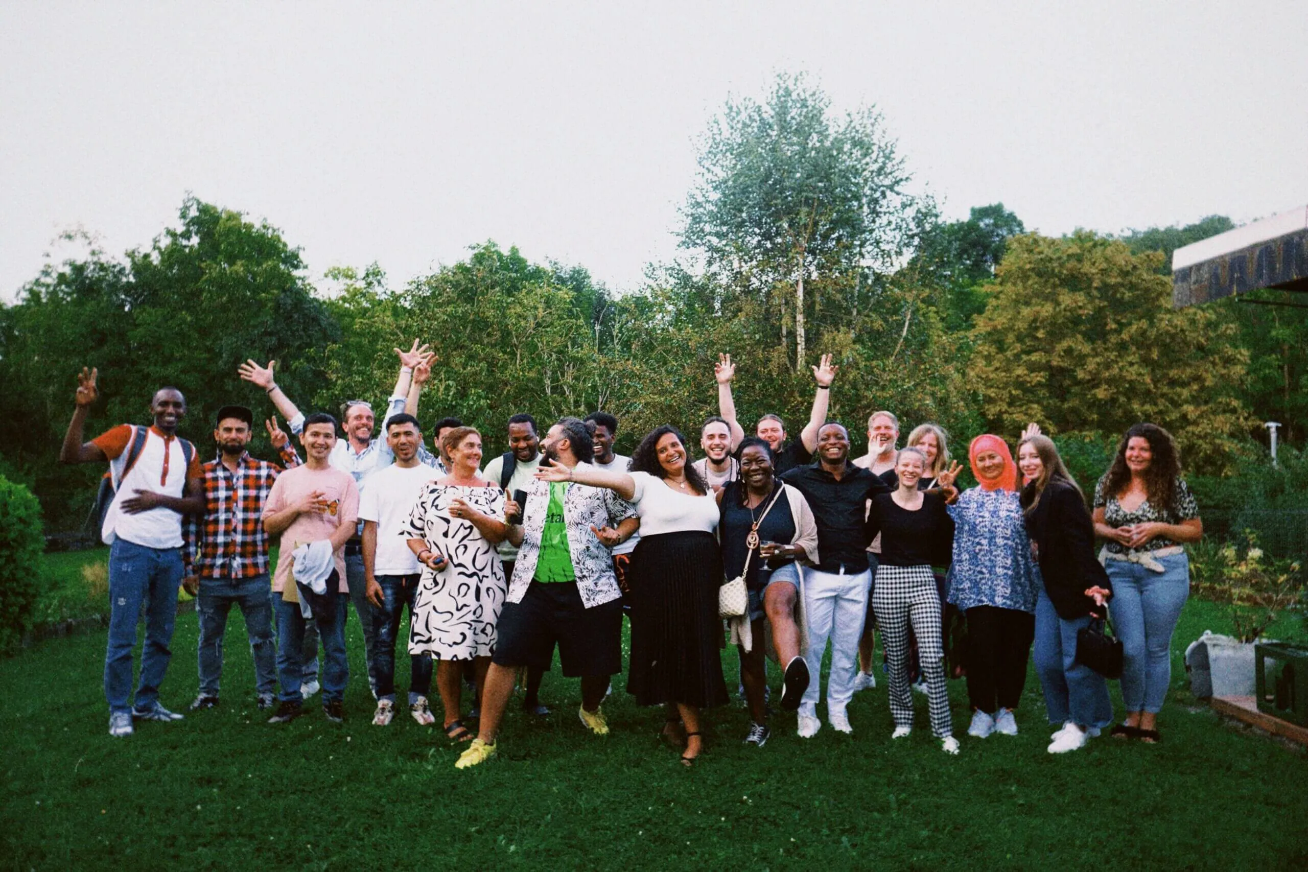 The Youth Work Synergy group, about twenty people cheering outdoors