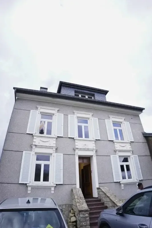 A YWS shared house in Luxembourg: a grey three-storey town house with white window surrounds