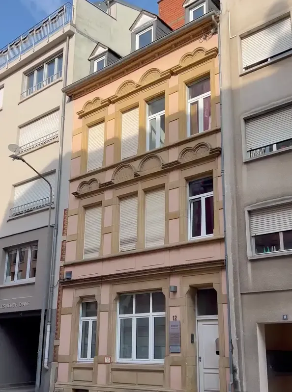A YWS shared house in Luxembourg: a narrow sandstone town house with carved window frames
